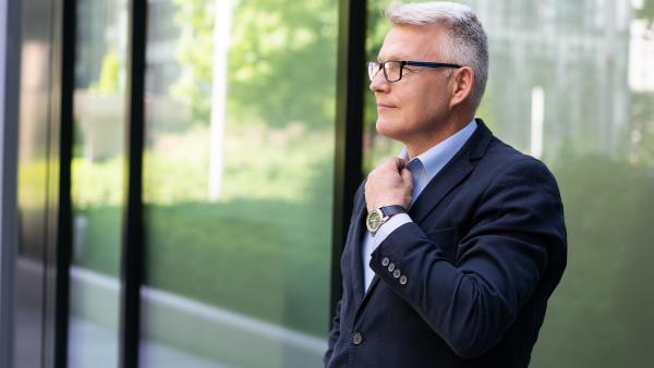 Good looking man next to window photo