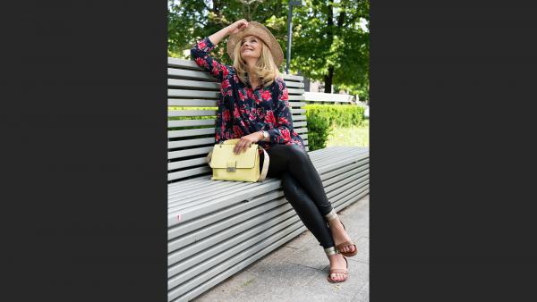 Woman sitting on bench in park