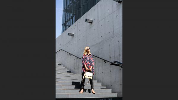 Woman standing on concrete stairs