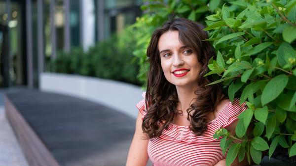 Girl on bench next to leaves