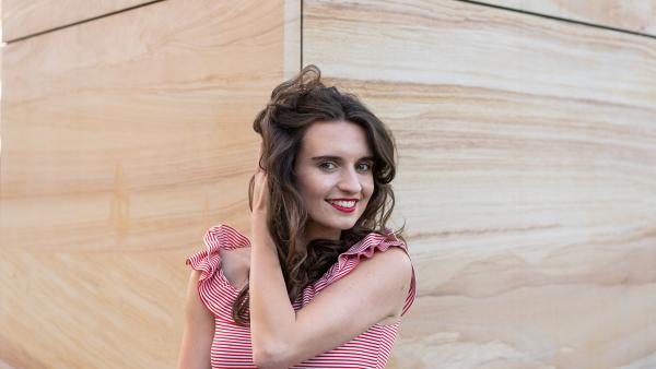 Young female in front of sandstone wall