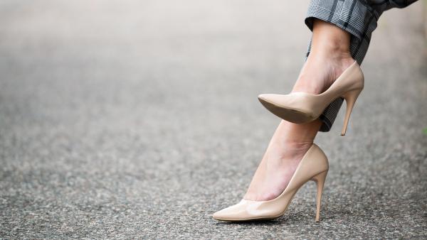 Woman legs on high-heeled shoes