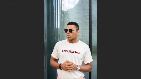 Man in t-shirt next to window